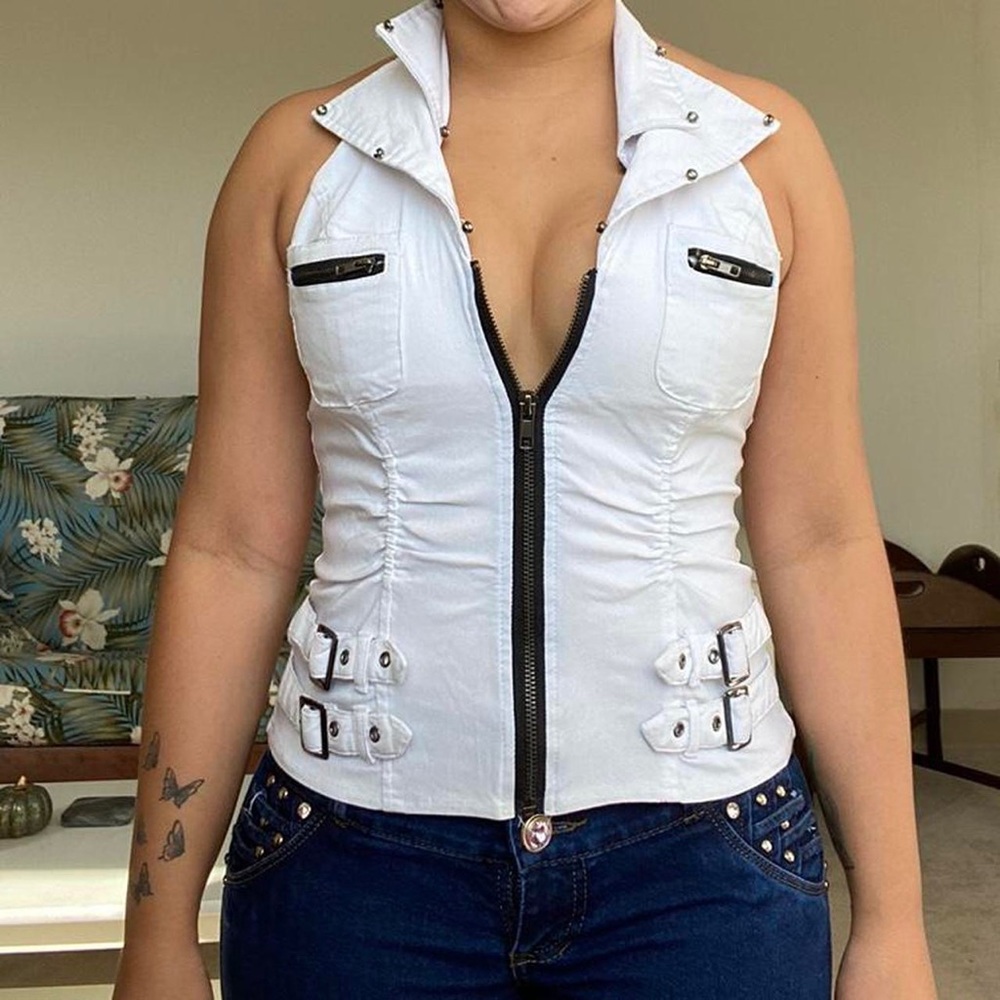 White collared zip up vest with a cinched waist, belts decorations